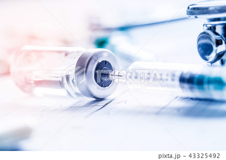 Medical syringe stethoscopeon on the EKG graph. Medical syringe stethoscopeon on the EKG graph. 43325492