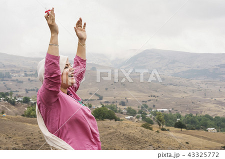 Happy Muslim woman with dummy at hand in outdoor a 43325772