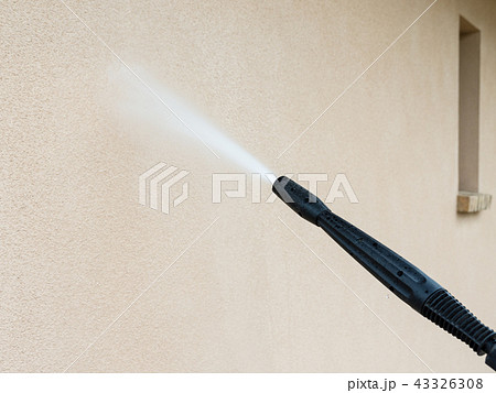 power washing the wall - cleaning the facade 43326308