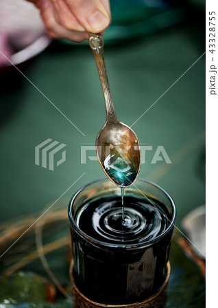 Tea with blue tea. Flower herbal tea.With a spoon drip a bit. 43328755