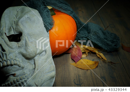 Pumpkin and halloween mask on old wood table 43329344