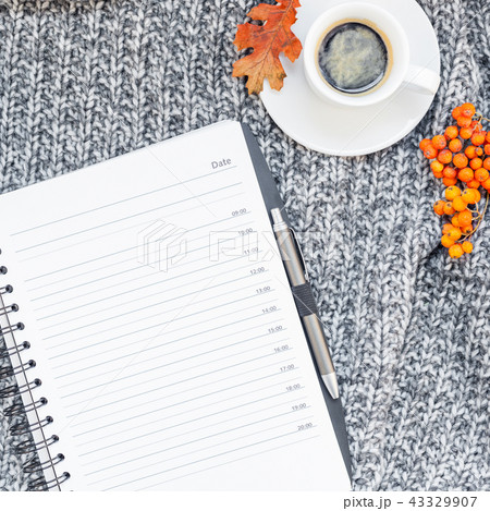 Home workplace with coffee cup on knitted plaid 43329907