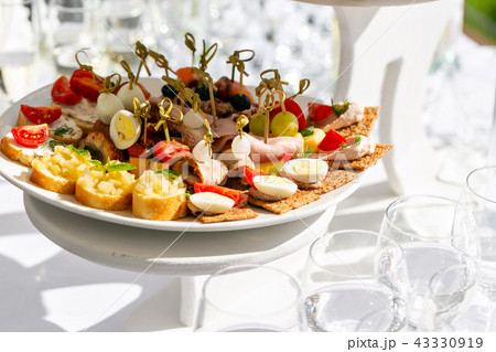 solemn banquet. Lot of glasses champagne or wine on the table in restaurant. buffet table with lots solemn banquet. Lot of glasses champagne or wine on the table in restaurant. buffet table with lots 43330919