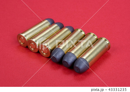 The .45 Revolver cartridges dating to 1872 on red The .45 Revolver cartridges dating to 1872 on red 43331235