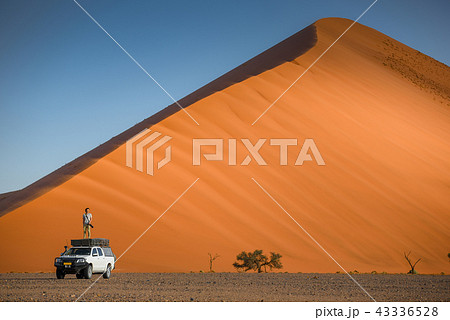 Asian man traveler on camper car near sand dune Asian man traveler on camper car near sand dune 43336528