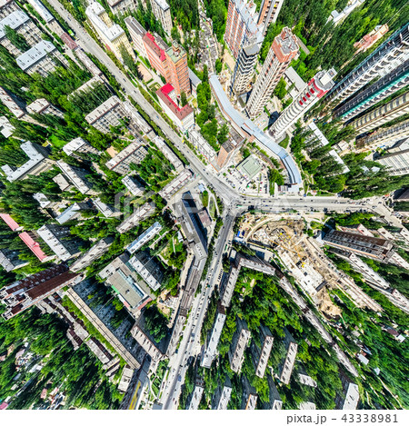 Aerial city view with crossroads and roads, houses, buildings, parks and parking lots. Sunny summer Aerial city view with crossroads and roads, houses, buildings, parks and parking lots. Sunny summer 43338981
