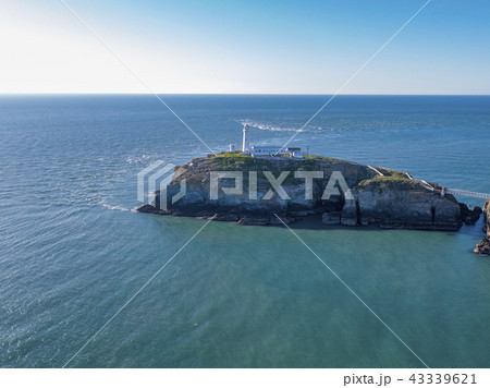 Aerial view of the beautiful cliffs close to the historic South Stack lighthouse on Anglesey - Wales Aerial view of the beautiful cliffs close to the historic South Stack lighthouse on Anglesey - Wales 43339621