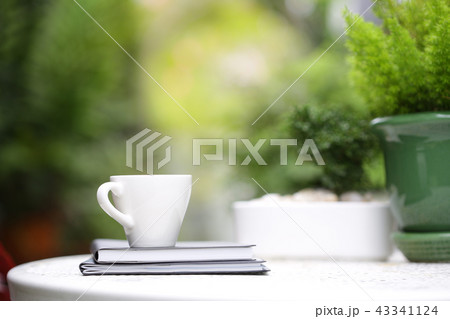 White coffee cup with notebooks at outdoor White coffee cup with notebooks at outdoor 43341124