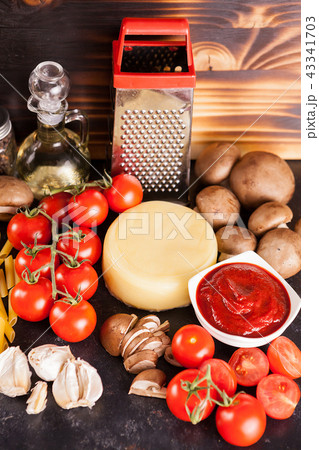 Raw uncooked spaghetti, pasta and macaroni on wooden background Raw uncooked spaghetti, pasta and macaroni on wooden background 43341703