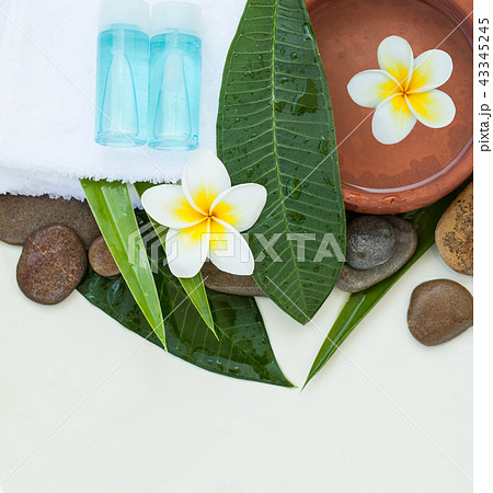 Spa or wellness setting with tropical flowers 43345245
