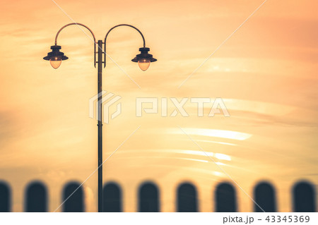 Street lamp during orange sunset Street lamp during orange sunset 43345369