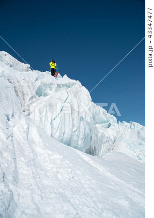 A freerider skier in complete outfit stands on a glacier in the North Caucasus. Skier preparing 43347477