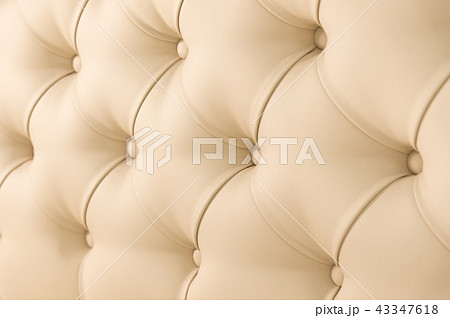 Beige soft tapestry pattern background with symmetrical buttons on the corners of diamonds. Soft and Beige soft tapestry pattern background with symmetrical buttons on the corners of diamonds. Soft and 43347618