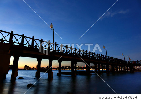 Night view of the wooden walkway with cityscape 43347834