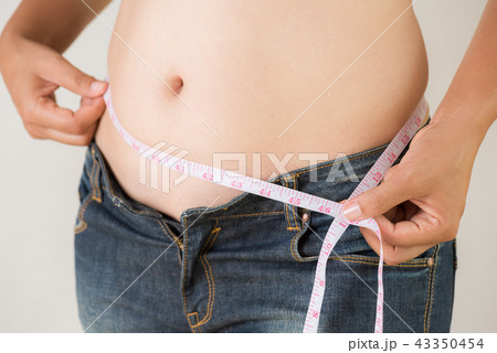Fat woman hand measuring waist Fat woman hand measuring waist 43350454