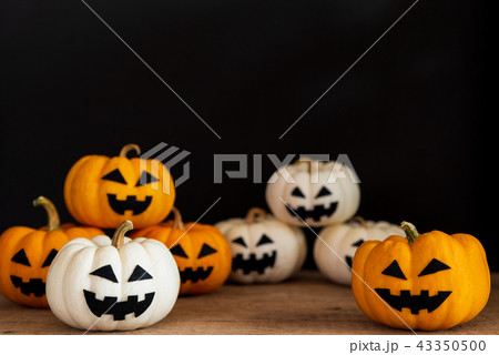 White and yellow ghost pumpkin on black background 43350500