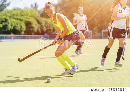 Young hockey player woman with ball in attack Young hockey player woman with ball in attack 43352014