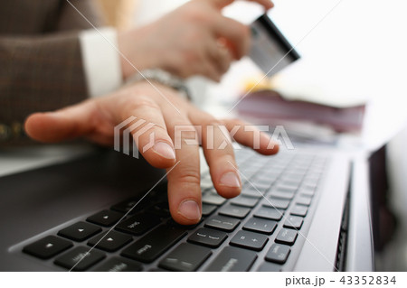Male arms hold credit card press buttons making transfer 43352834