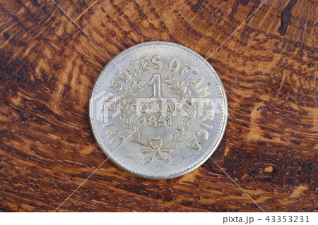 antique silver dollar on wooden background antique silver dollar on wooden background 43353231