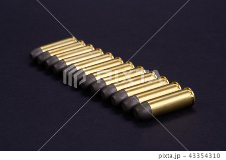 Wild West Revolver cartridges on black background Wild West Revolver cartridges on black background 43354310