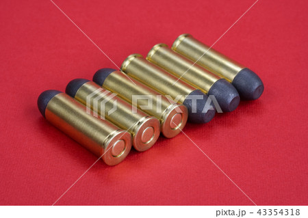 Wild West Revolver cartridges on red background 43354318