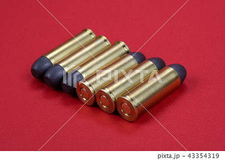 Wild West Revolver cartridges on red background 43354319