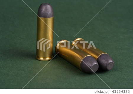 Wild West Revolver cartridges on green background 43354323