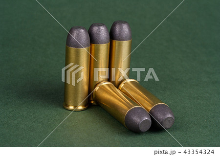 Wild West Revolver cartridges on green background 43354324