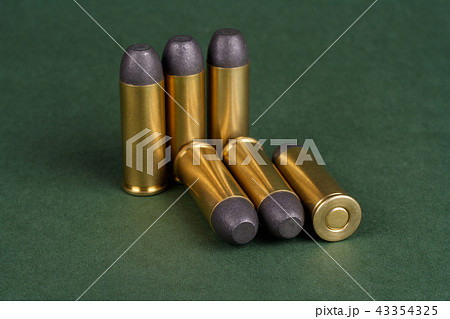 Wild West Revolver cartridges on green background 43354325