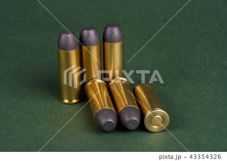 Wild West Revolver cartridges on green background 43354326