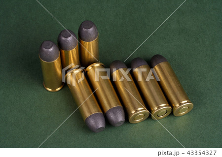 Wild West Revolver cartridges on green background 43354327