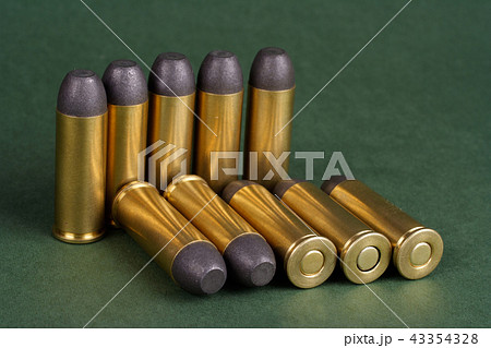 Wild West Revolver cartridges on green background 43354328