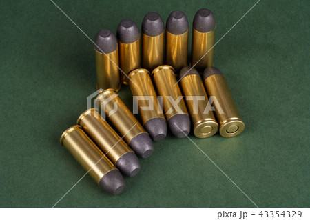 Wild West Revolver cartridges on green background 43354329