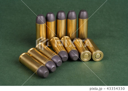 Wild West Revolver cartridges on green background 43354330