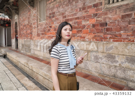 asian woman searching something by the mobile. 43359132