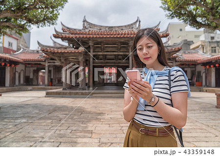elegant asian woman searching by the phone elegant asian woman searching by the phone 43359148
