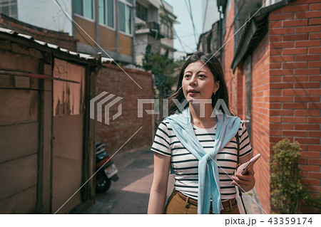 asian visitor strolling in the old street. 43359174