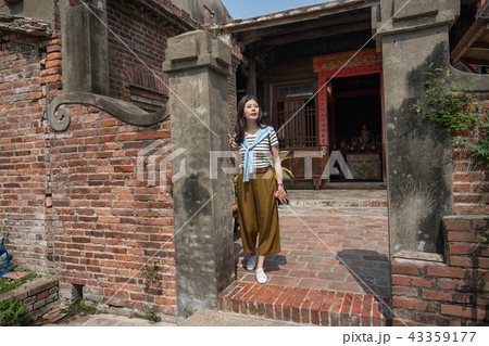 standing in the old tranditional house. 43359177