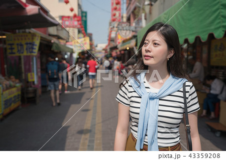 asian female smiling and visiting the traditional market. 43359208