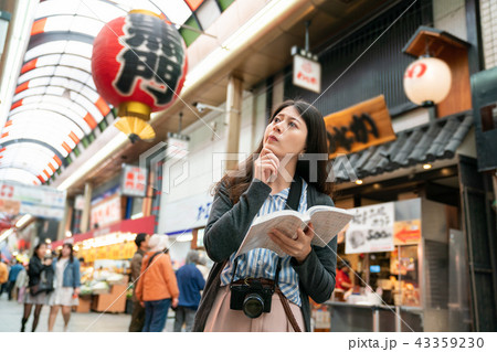 asian visitor feeling confused in the street. asian visitor feeling confused in the street. 43359230
