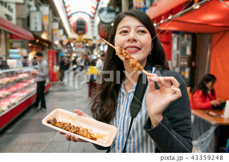 Pretty woman enjoying the street food. Pretty woman enjoying the street food. 43359248