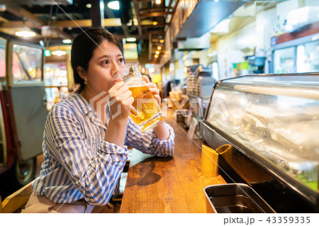 asian woman drinking at the counter of izakaya. asian woman drinking at the counter of izakaya. 43359335