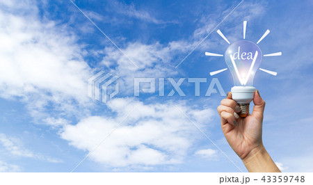 Idea concept hand holding lamp sky background. Idea concept hand holding lamp sky background. 43359748