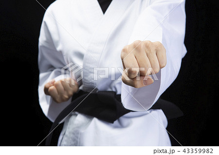 正拳突きを繰り出す女性空手家の拳の写真素材