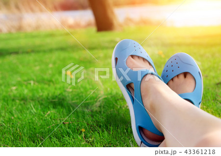 Relaxing young woman in a meadow in the summer sun Relaxing young woman in a meadow in the summer sun 43361218