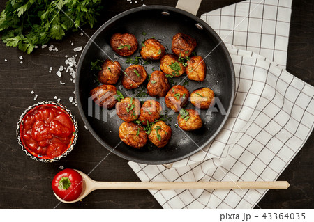 meatballs with parsley in a pan on a black old wooden table 43364035