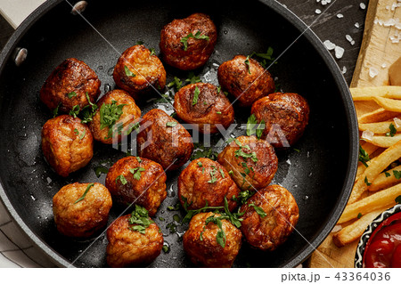 meat balls in a pan and golden crispy fries on a black old table meat balls in a pan and golden crispy fries on a black old table 43364036
