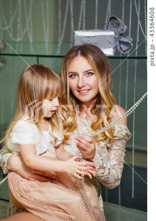 Mother and daughter hugging Mother and daughter hugging 43364608
