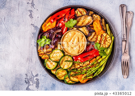 Grilled vegetables on a plate with sauce. 43365012
