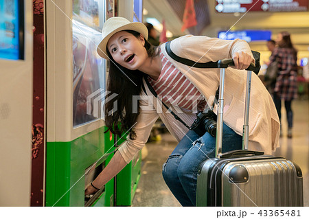 visitor taking things from vending machine. 43365481